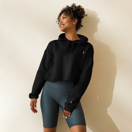 A woman posing wearing a black 905 streetwear item